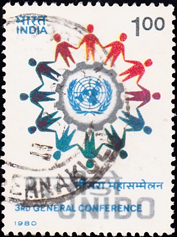 UNIDO : Ring of People encircling U.N. Emblem and Cog-Wheel